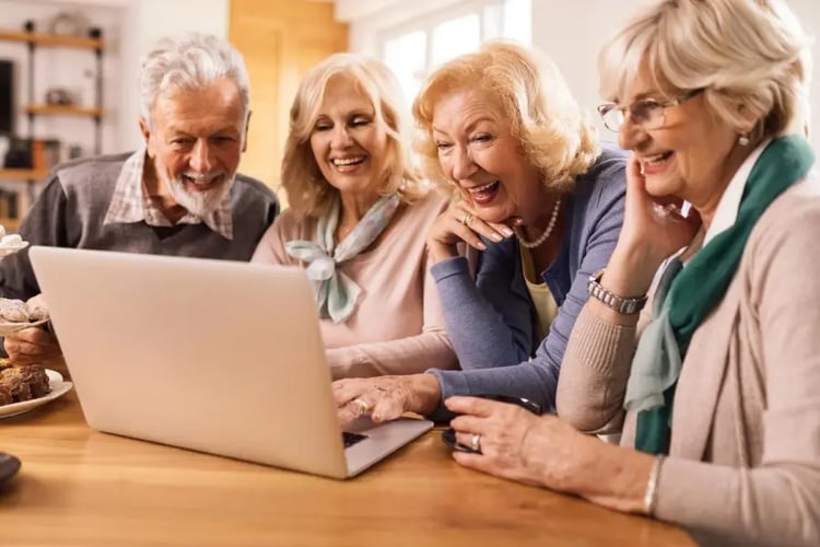 group-happy-mature-friends-having-fun-while-surfing-net-computer-home